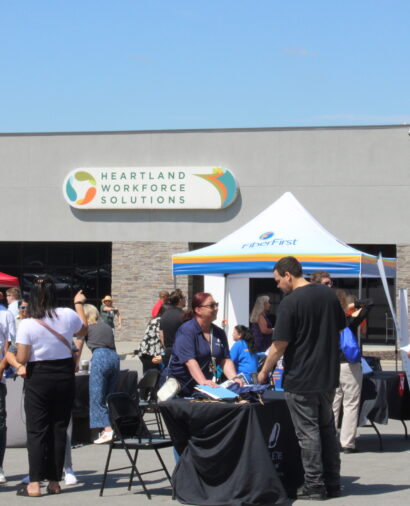 The Ames location during Jobapalooza. Many people are smiling and walking around in the sunshine.